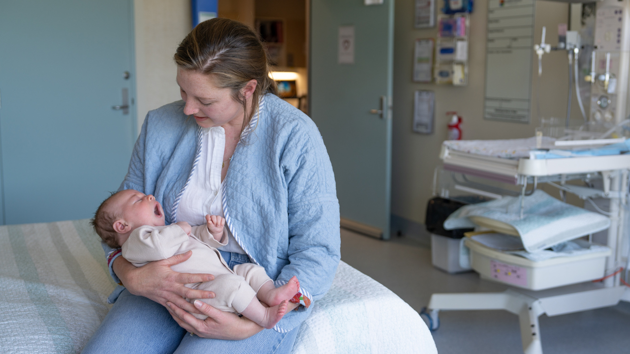 Mother holding a baby in a hospital room