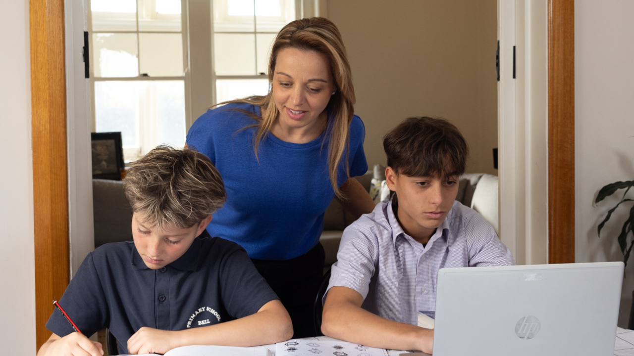 Mother with two children doing homework on a table