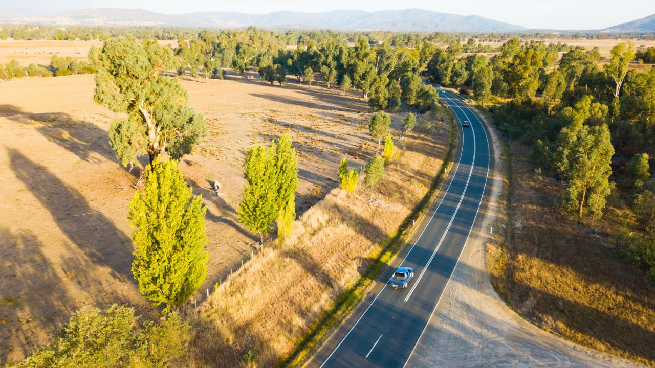 Aerial photo of a car driving along a regional road Aerial photo of a car driving along a regional road
