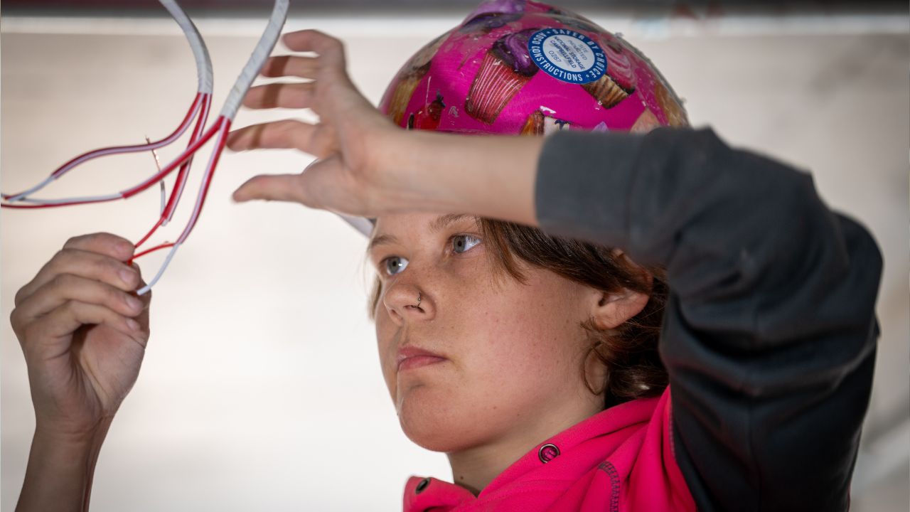Female electrician working indoors Female electrician working indoors