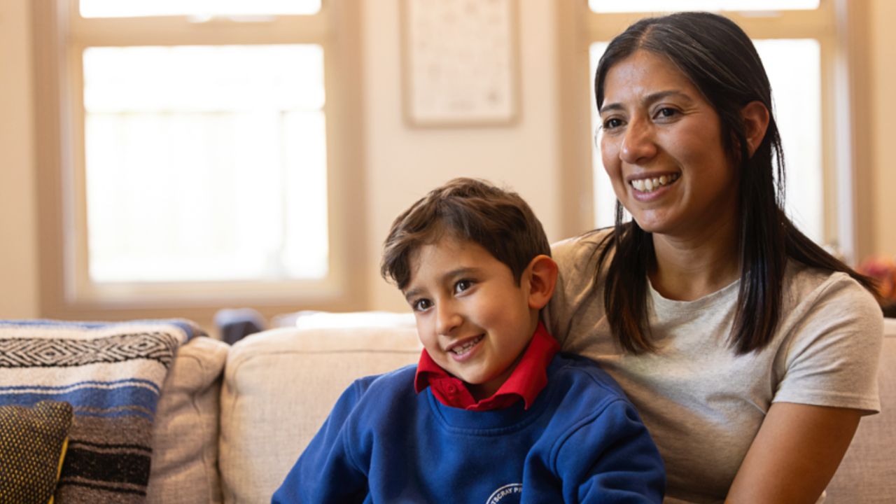 Mother and her child sitting in their lounge room Mother and her child sitting in their lounge room