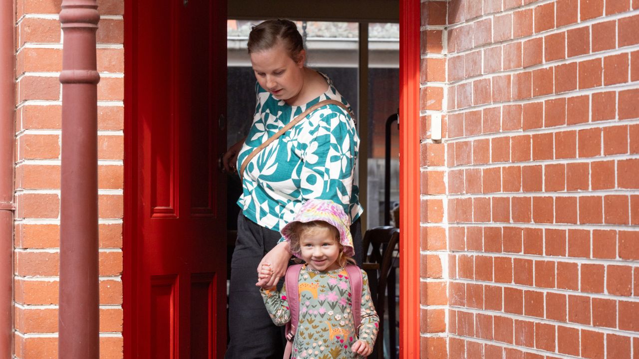 Mother leaving her home with young daughter Mother leaving her home with young daughter