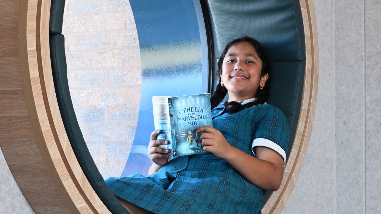 Student reading a book inside a school Student reading a book inside a school