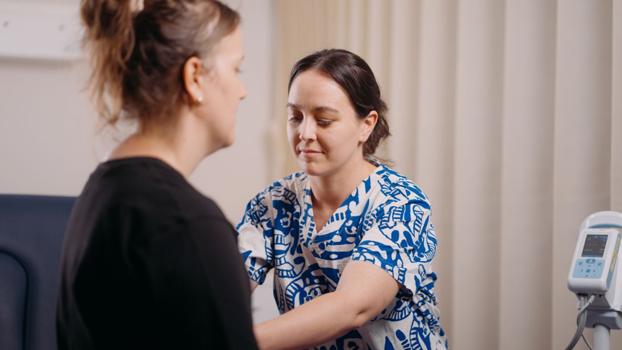 Healthcare worker treating a patient in a hospital setting