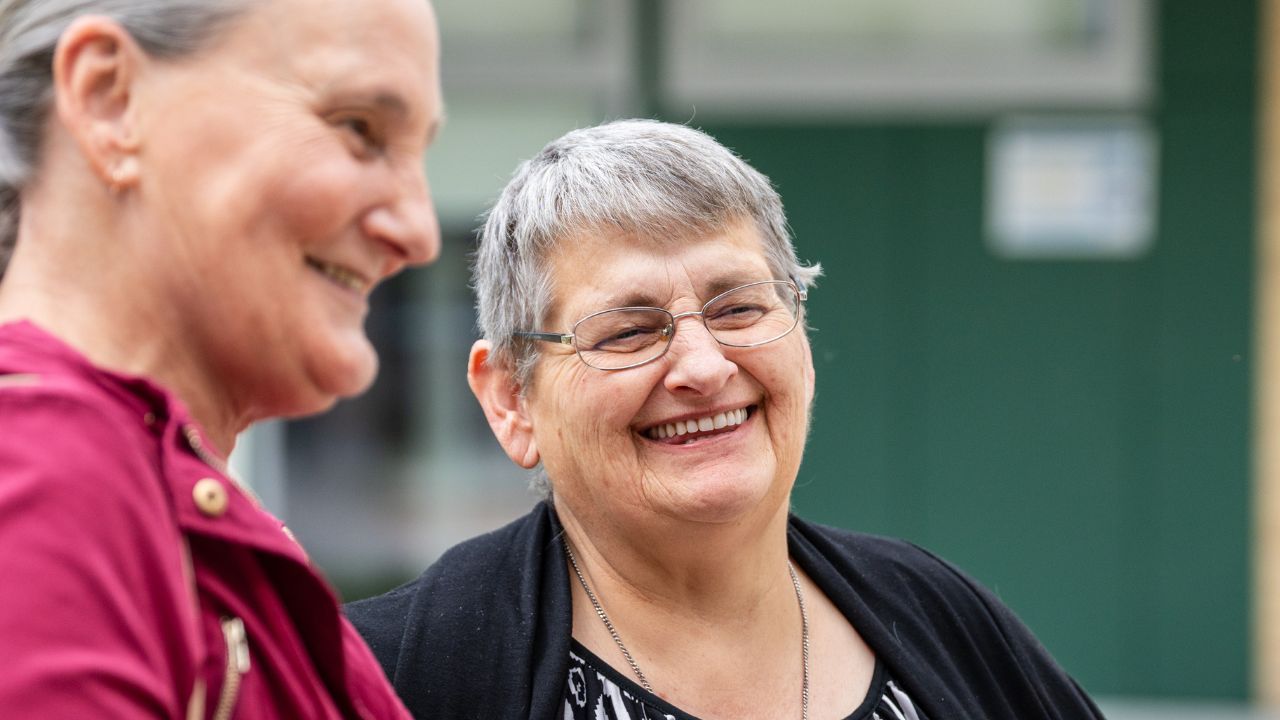 Two women talking outside